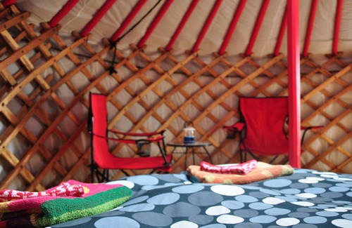 Indian Brook Resort | Small red yurt at Cabot Shores Wilderness Resort