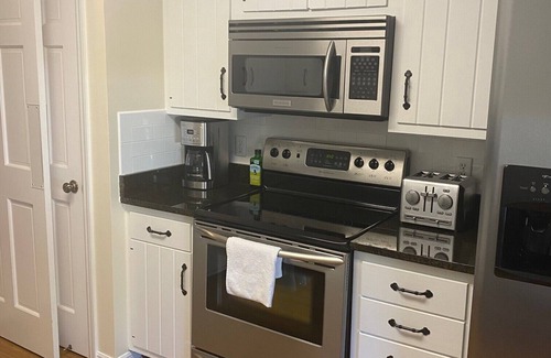 Indian River Shores Condo | Spacious condo with views of oak canopy, gardens & pool. 5-minute walk to beach.