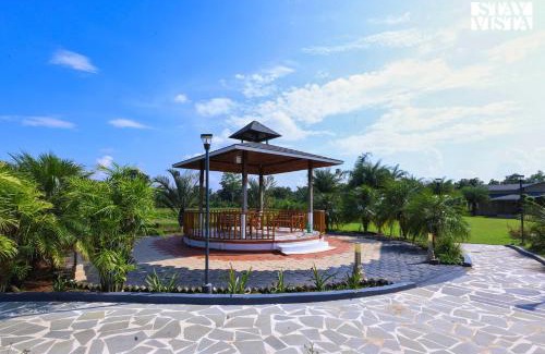 Jabalpur Villa | StayVista at Riverfront Cottage with Scenic River view, BBQ, Bonfire, Gazebo, Pet friendly