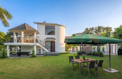 Ludhiana Villa | StayVista's The Secret Lagoon with Outdoor Pool, Verdant Lawn & Indoor-Outdoor Activities