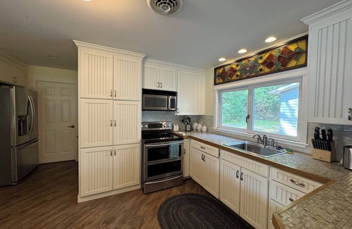 Sanbornville House | Stunning lakefront home with a boathouse, private dock, firepit and lake views