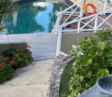 Dickenson Bay Apartment | Swimming Pool- Balcony Veranda- Sea & Sunset Views