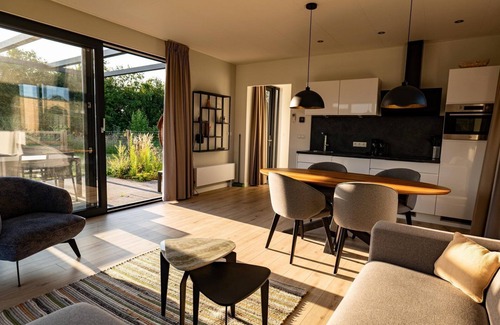 Lattrop House | The Amalia is a 4-person holiday home featuring a cozy, homely living room with an open kitchen, 2 bedrooms, a spacious outdoor area, and a hot tub.