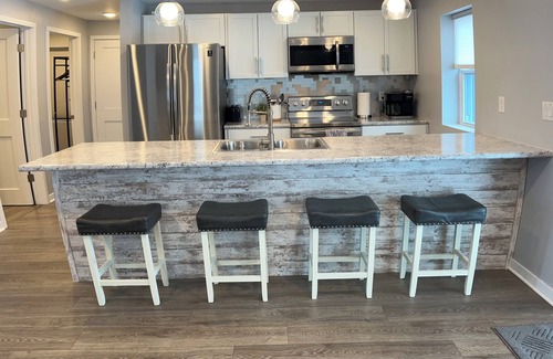 Oconto House | The Blue Riverside Home in Oconto
