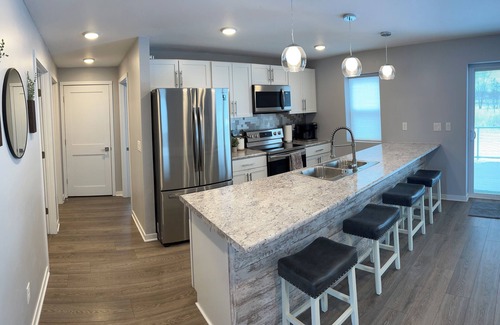 Oconto House | The Blue Riverside Home in Oconto