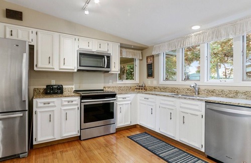 Powers Lake House | The Lake House on Powers |Grassy Frontage |Lakeside Deck |Rec Room w/Pool Table & Bar |Fire Pit