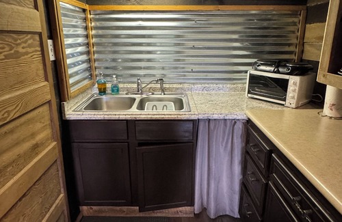 Pineville Cabin | The Little Sugar Shack, a rustic tiny cabin with hot tub access & fiery sunsets!