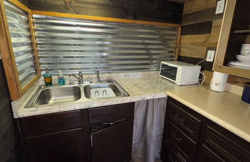 Pineville Cabin | The Little Sugar Shack, a rustic tiny cabin with hot tub access & fiery sunsets!