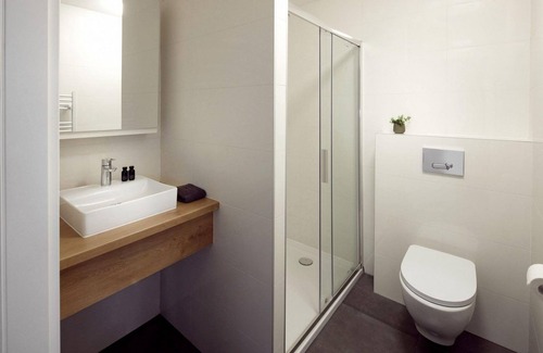 Kotten Hotel | The luxurious two-person hotel studio with a beautiful patio, high windows and sliding doors offers a surprising amount of privacy, space and comfort.