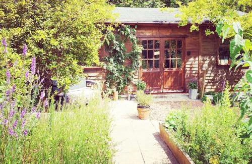 Kilgetty Apartment | The Potting Shed near Tenby, 100" Projector, Four poster bed, On-site HOT TUB access via Spa Pack