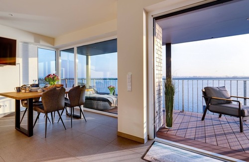 Kappeln Apartment | The Wave: luxury holiday apartment right on the water with heated lounger, sauna and fireplace