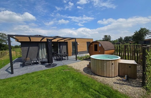 Lattrop House | This holiday home with a fully enclosed dog fence, private sauna and hot tub features a cosy, homely living room with open kitchen, 2 bedrooms and a spacious outdoor area.