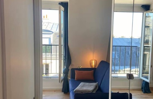 Champs-Elysees Apartment | Top floor Paris studio - view of rooftops and monuments