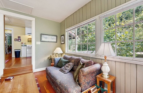 Molalla Cottage | Tranquil landscape with riverside firepit, gas grill, gas fireplace, and deck