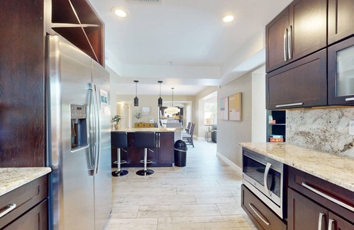 Cocoa Isles House | Tropical home with pool, lovely patio & game room - walk to beach