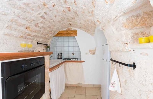 San Michele Salentino Villa | Trullo with private pool - garden games - outdoor kitchen - wood-burning oven
