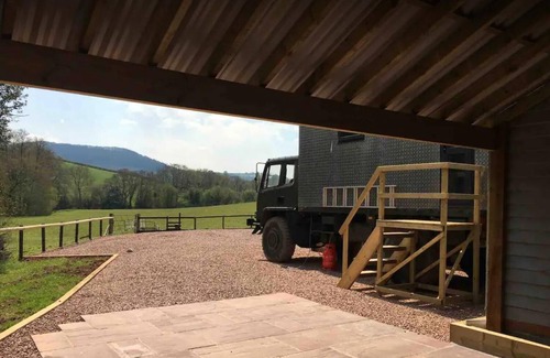 Usk House | Unique stay in your very own army truck. Sleeps 4. Hot tub. Tranquil setting.