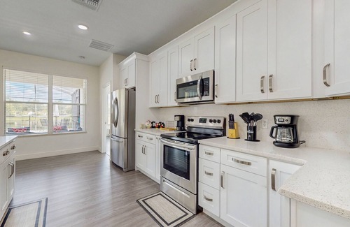 Trafalgar Village House | Water view retreat with lanai, heated pool, pool spa, game room, & AC