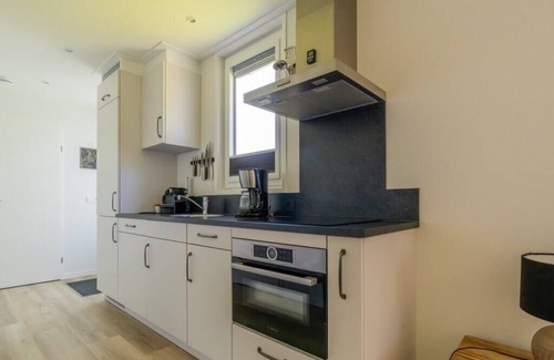 Burgh-Haamstede House | What immediately catches your eye upon entering is the garden-oriented living room with open kitchen