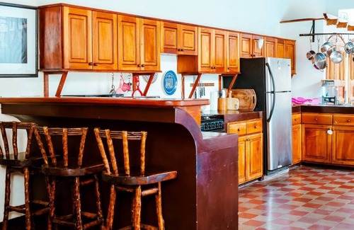 Granada House | You’ll know that you have rented a historic colonial home when you pass through huge, antique front doors framed by 3 foot-thick adobe walls. Lounge on the shallow, submerged bench seats in the pool or in the hammocks hanging between 12 foot wooden c