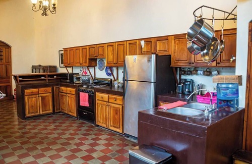 Granada House | You’ll know that you have rented a historic colonial home when you pass through huge, antique front doors framed by 3 foot-thick adobe walls. Lounge on the shallow, submerged bench seats in the pool or in the hammocks hanging between 12 foot wooden c