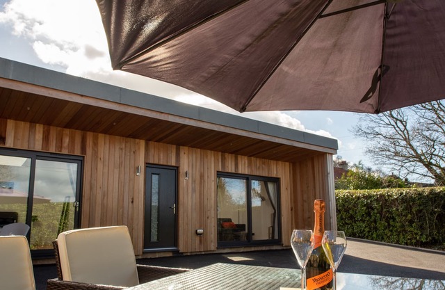 A contemporary cedar clad lodge adjacent to a national cycle route