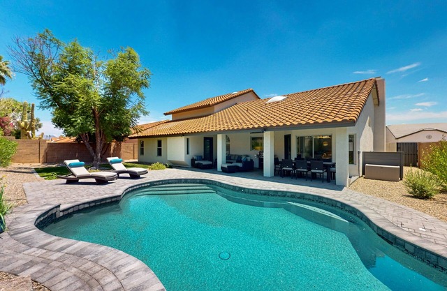 A stately luxury house with pool nestled in a serene neighborhood