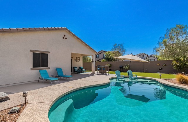 Airy desert home with an enclosed yard, private pool, hot tub, firepit, & W/D
