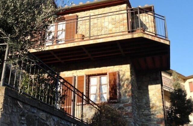 Beautiful stone house in Tuscany with terrace and balcony.