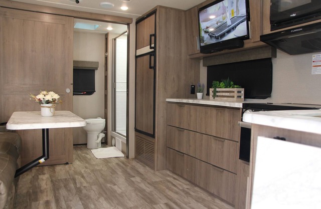 Cozy new trailer situated near restaurants and stores .