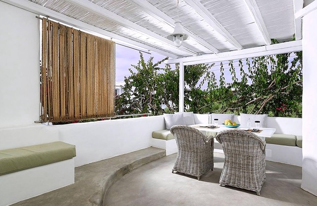 Endearing Milos Suite | Cycladic Light Suite | Private Furnished Balcony | Outdoor Dining Area |.