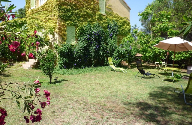 House and garden near sea, mountain and river