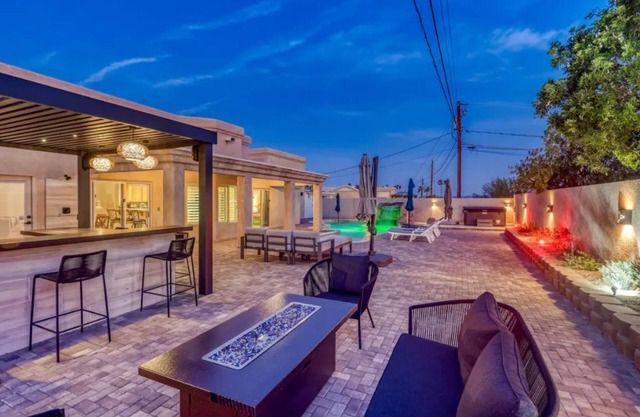 Huge backyard with pool, hot tub, BBQ, and putting green.