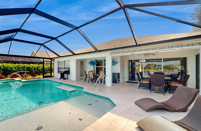 Lakefront home with private heated outdoor pool, enclosed lanai, & central AC