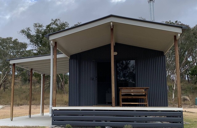 Modern studio cabin set amongst vineyards, bushland and grazing paddocks.