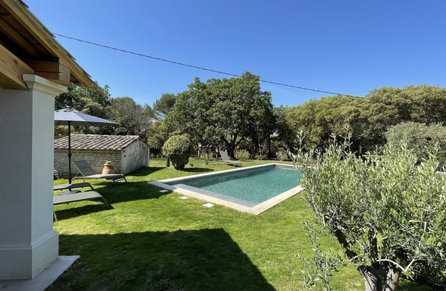 Provencal farmhouse on a hillside surrounded by centuries-old olive and oak trees