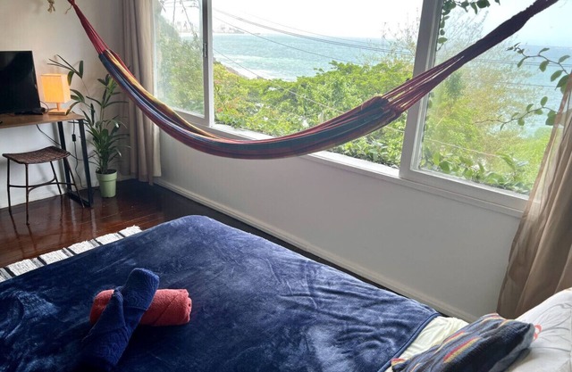 Relax and watch the sunrise across the ocean from your hammock. Views of Ipanema across the water