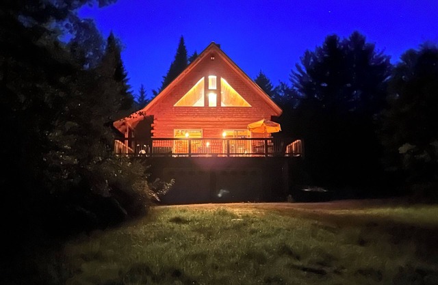 Ride right from this trailside cozy cabin in the woods with private pond.