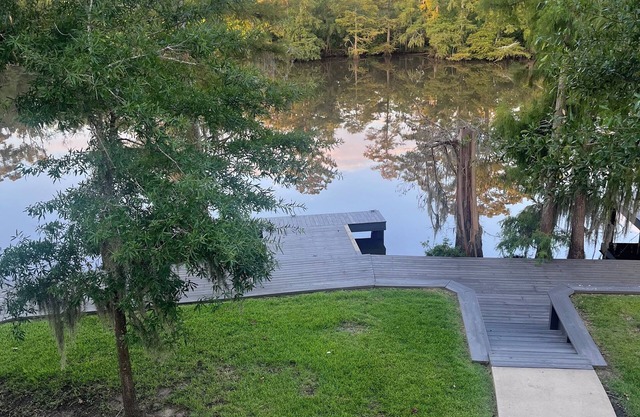 River front paradise with large dock and outdoor space, great for entertaining.