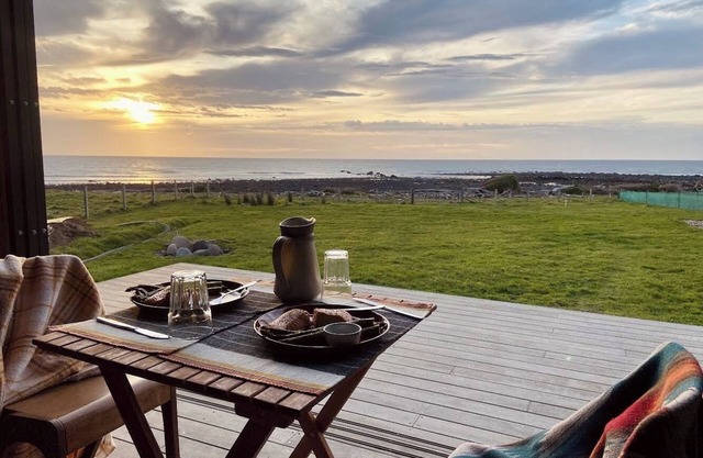 Sauna, seafront, and architecture steps away from the Tasman Sea