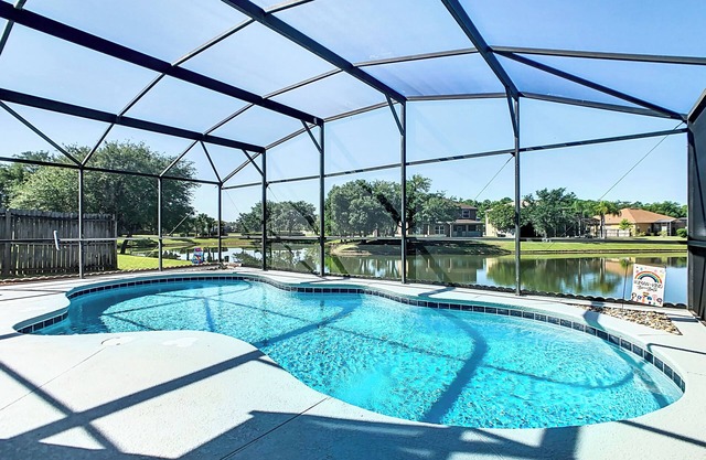 Smiling Disney Oasis heated pool home in Kissimmee with Game room.