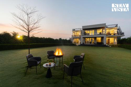 StayVista at Olive Farms with Lawn, Pool, Bonfire & Hill Views