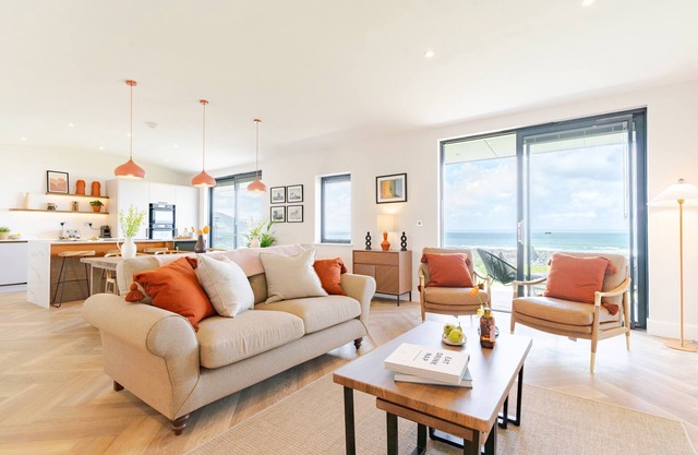 The Lighthouse is an end of terrace four bedroomed seafront retreat with a hot tub and incredible vi