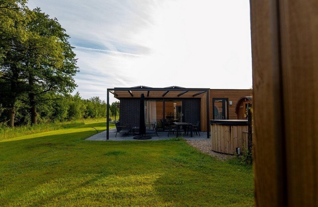 This vacation home, with a private sauna and hot tub, has a cozy homey living room with an open kitchen, 2 bedrooms, and generous outdoor space.