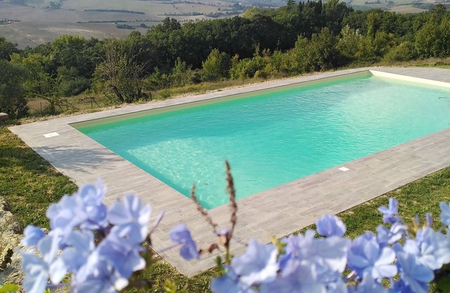 typical farmhouse with swimming pool in the green Umbrian hills