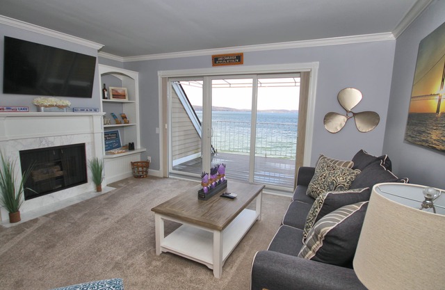 Vaulted Ceilings + Prime Lake Charlevoix Views | Fireplace | Private Patio|