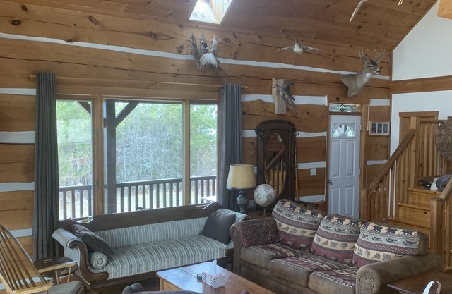 Waterfront log home on Lake Dore. Decks, dock, outdoor hot tub and fire pit.