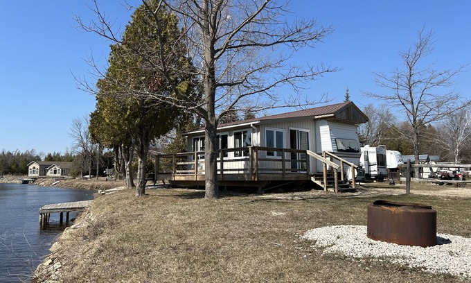 Stokes Bay RV Rental | #0 Enjoy a waterfront view from your own trailer with a deck & sunroom