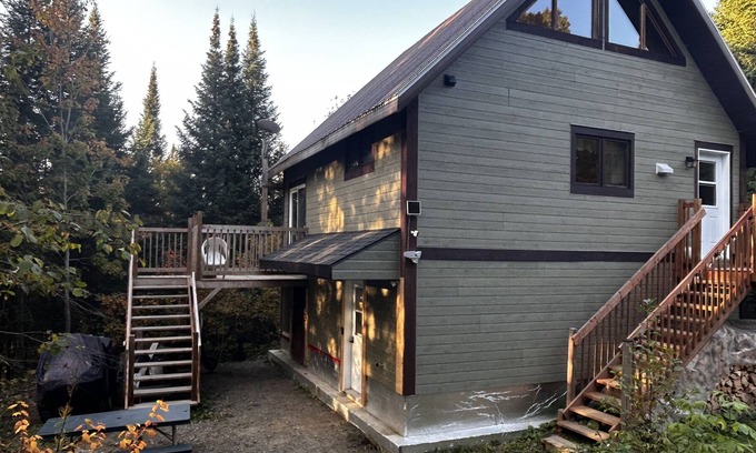 Notre-Dame-Des-Bois Cabin | A cozy rustic mountain side cabin with a small river on the property.