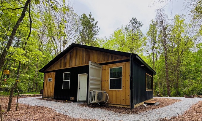 Lapeer Cabin | Beehive shipping container cabin surrounded by nature and a pond